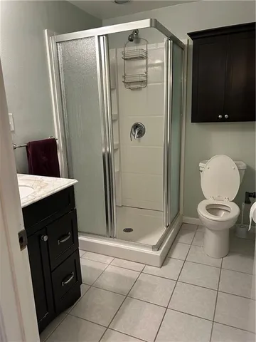 a view of a room with wooden floor and fan