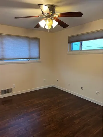 a view of a room with a window and wooden floor