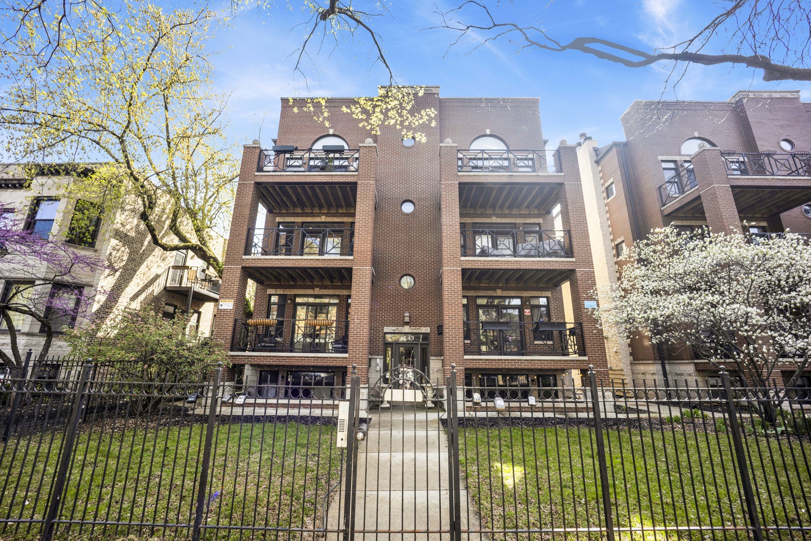 4543 North Malden Street, Unit 2N Chicago, IL 60640 - Photo 1 of 25 a front view of a building with glass windows and a table and chairs