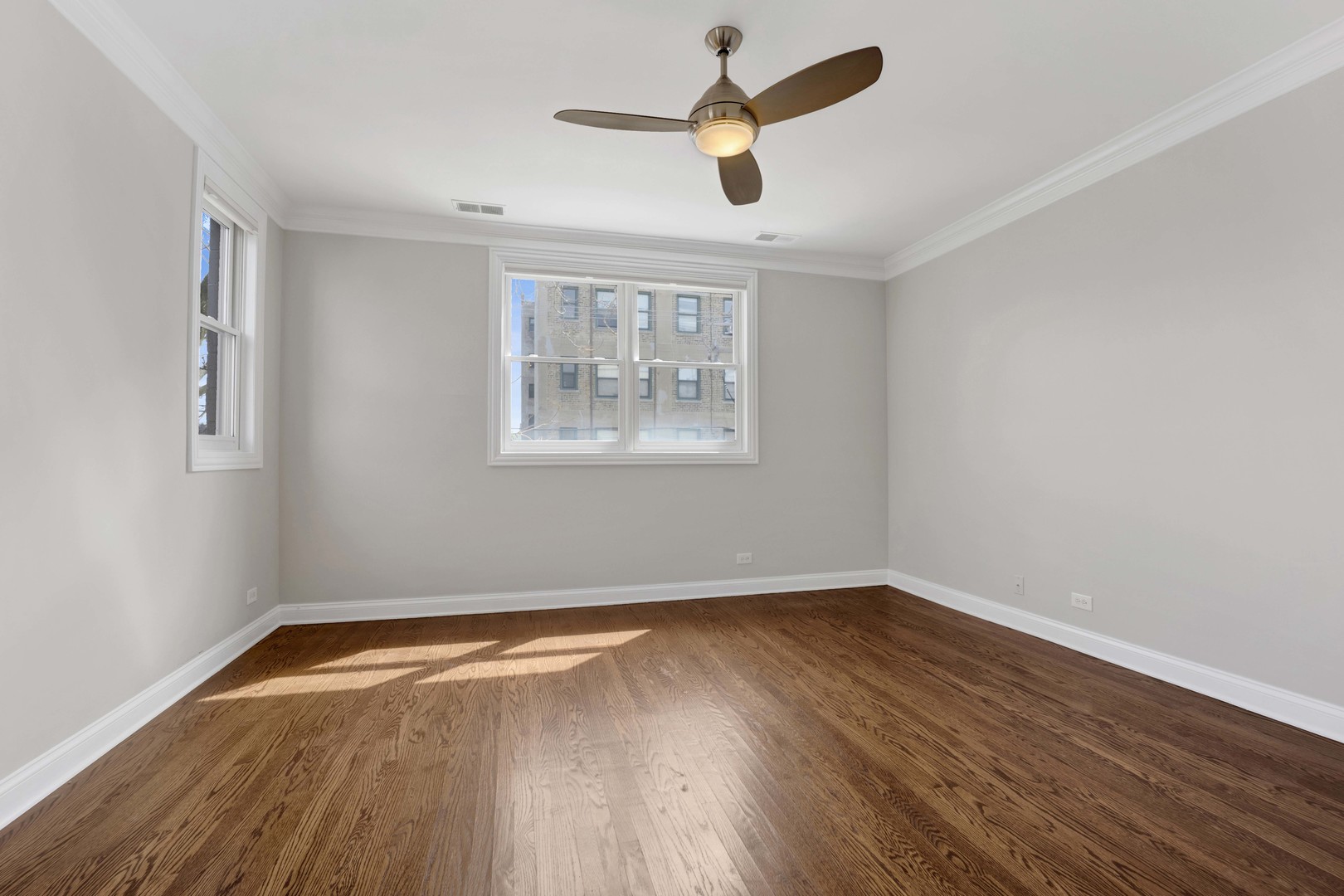 4543 North Malden Street, Unit 2N Chicago, IL 60640 - Photo 16 of 25 an empty room with wooden floor and windows