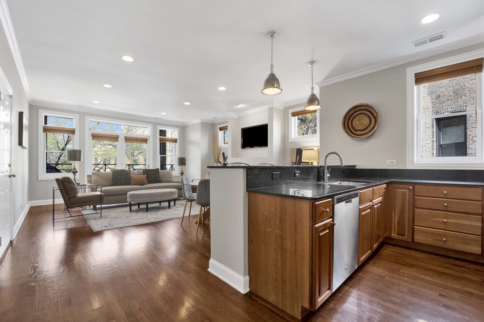 4543 North Malden Street, Unit 2N Chicago, IL 60640 - Photo 10 of 25 a large kitchen with stainless steel appliances granite countertop a stove and a wooden floors