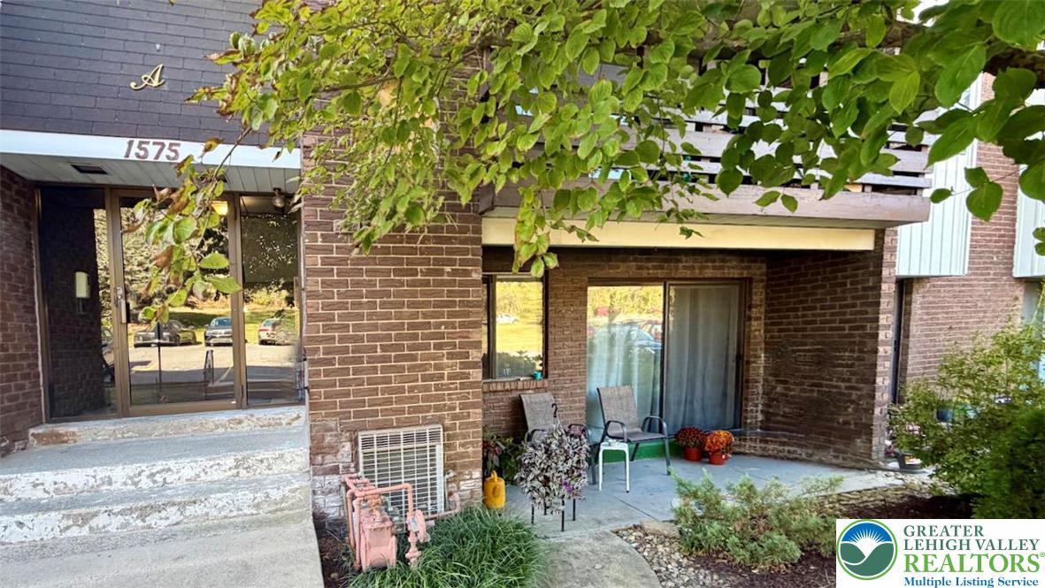 1575 Creekside Road, Unit A2 Whitehall, PA 18052 - Photo 1 of 21 a front view of a building with garden