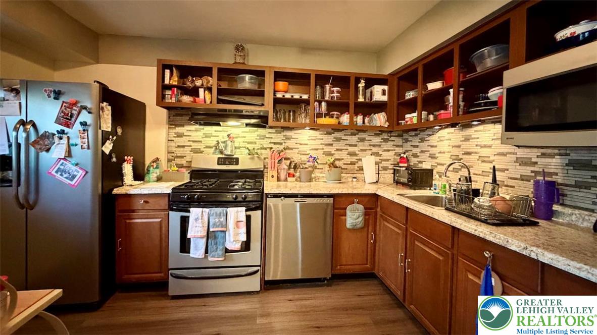 1575 Creekside Road, Unit A2 Whitehall, PA 18052 - Photo 13 of 21 a kitchen with stainless steel appliances granite countertop a stove and cabinets