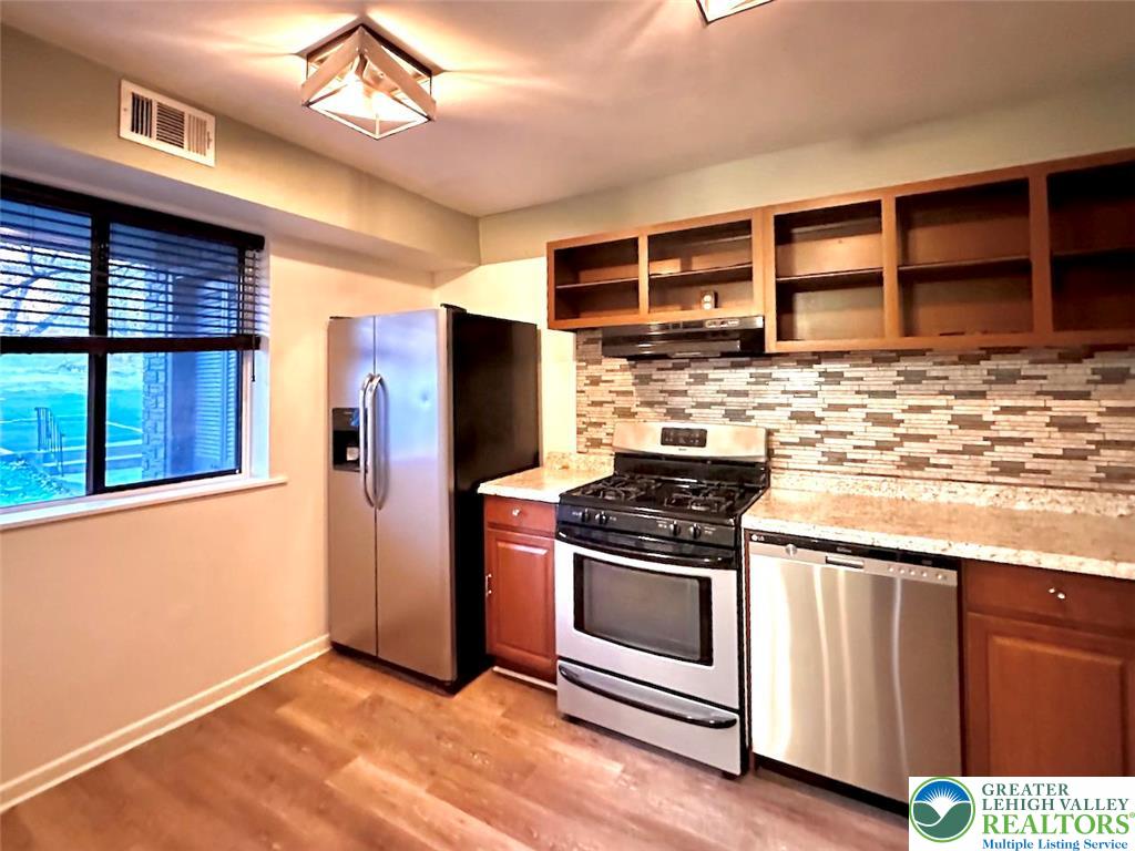 1575 Creekside Road, Unit A2 Whitehall, PA 18052 - Photo 14 of 21 a kitchen with stainless steel appliances granite countertop a stove and a refrigerator