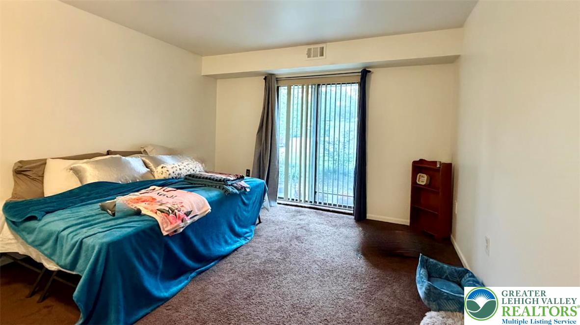 1575 Creekside Road, Unit A2 Whitehall, PA 18052 - Photo 15 of 21 a bedroom with a bed and a mirror