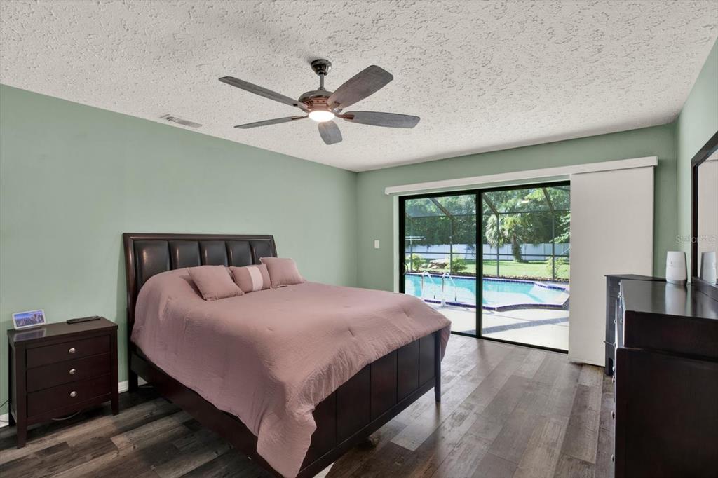 7487 River Country Drive Weeki Wachee, FL 34607 - Photo 27 of 53 a bedroom with a large bed and a large window