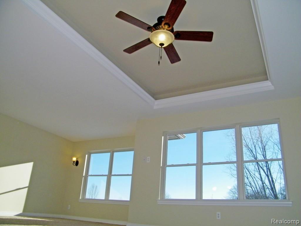 5415 Inverrary Lane Commerce Township, MI 48382 - Photo 13 of 18 EXTRA LARGE MASTER BEDROOM FEATURES TRAY CEILING WITH FAN/LIGHTING, WALL SCONCES, AND LARGE ENERGY EFFICIENT WINDOWS FOR LOTS OF NATURAL LIGHT