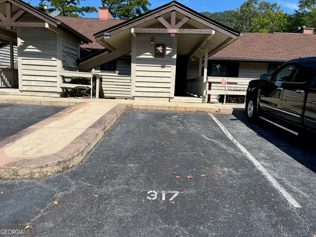 a view of a car park in front of house