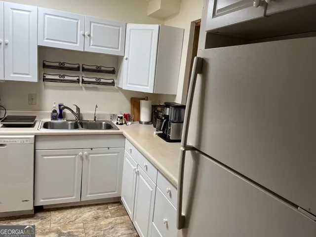a kitchen with stainless steel appliances a sink and cabinets