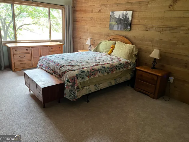 a bedroom with a bed and window