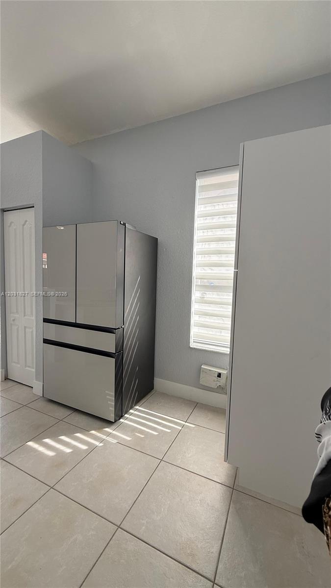 2120 Northeast 37th Road, Unit 1 Homestead, FL 33033 - Photo 19 of 30 a kitchen with a cabinets and a refrigerator
