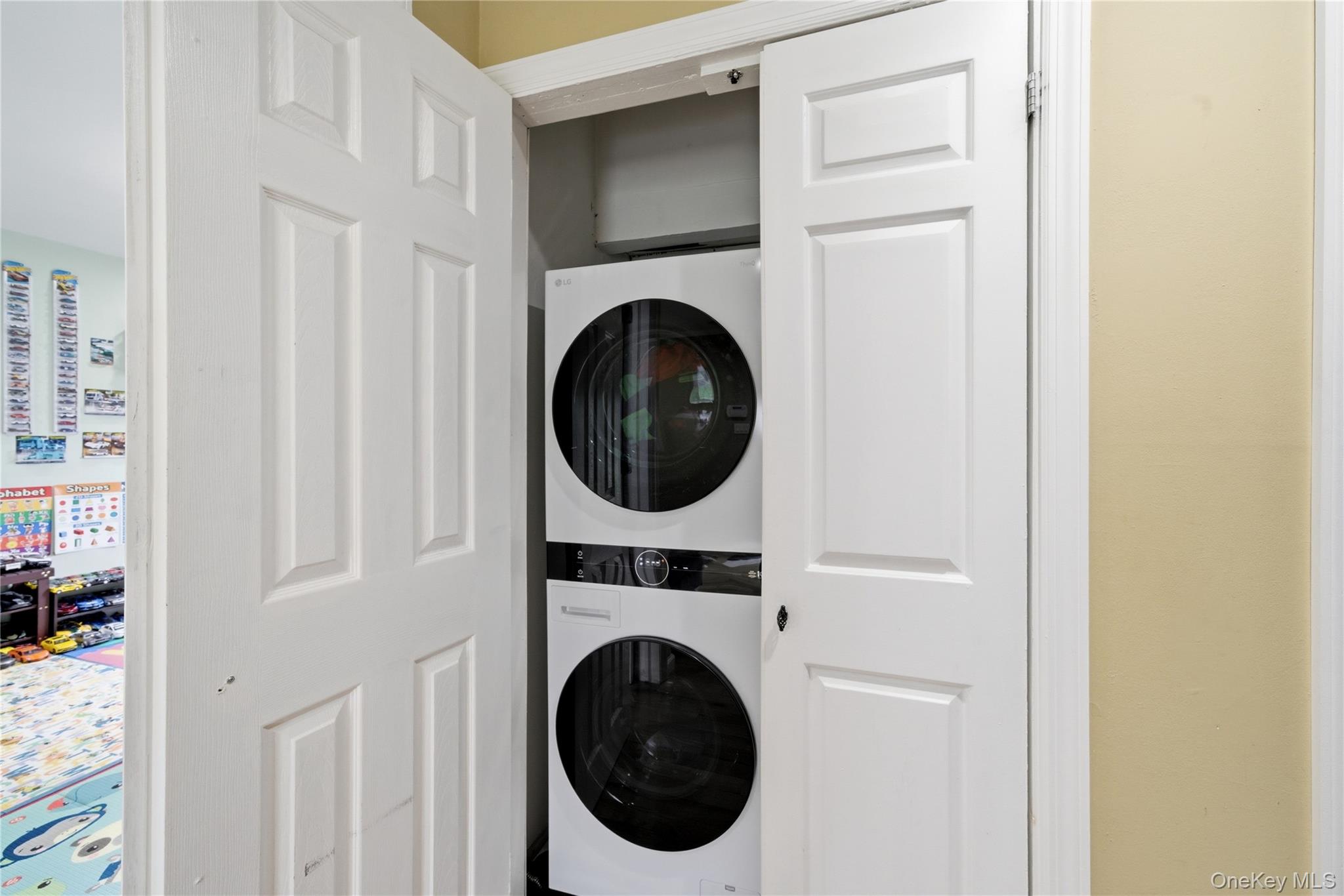 50 Ridge Lane Levittown, NY 11756 - Photo 22 of 27 a view of a hallway with washer and dryer
