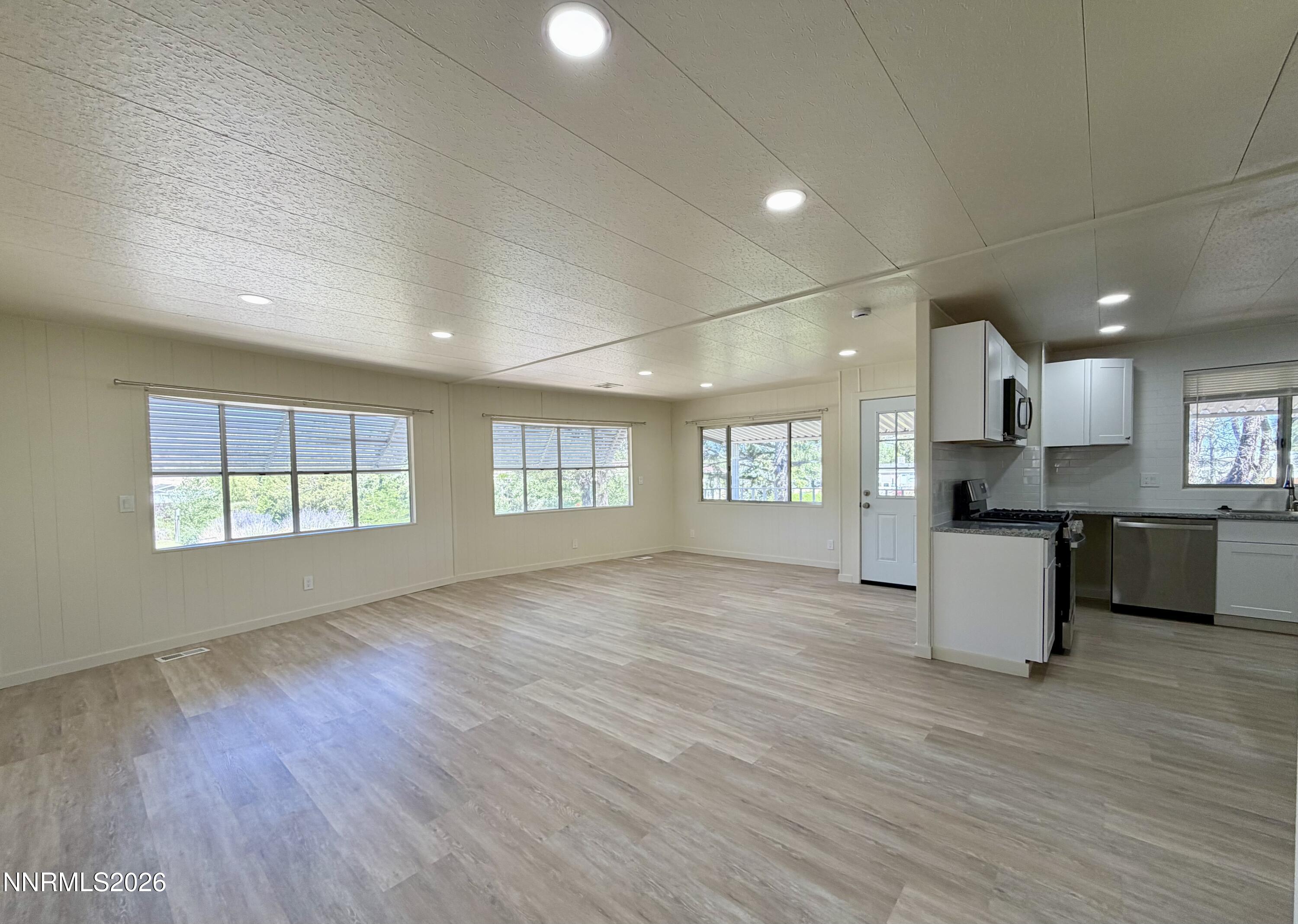 330 Taurus Circle Reno, NV 89521 - Photo 7 of 27 an empty room with windows and kitchen view