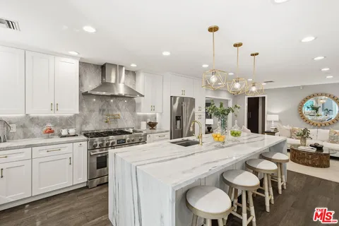 a kitchen with a stove a sink and a refrigerator