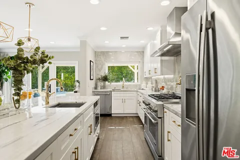 a kitchen with a sink stove and refrigerator