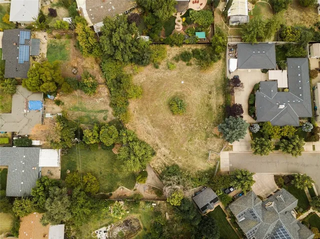 an aerial view of residential houses with yard