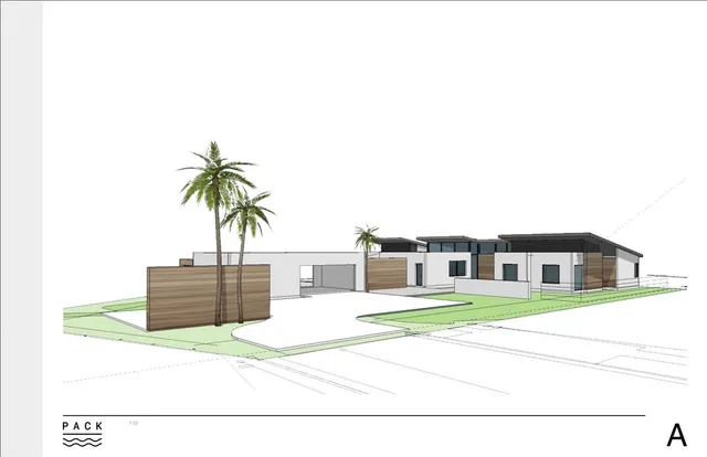 an aerial view of residential houses with outdoor space and trees