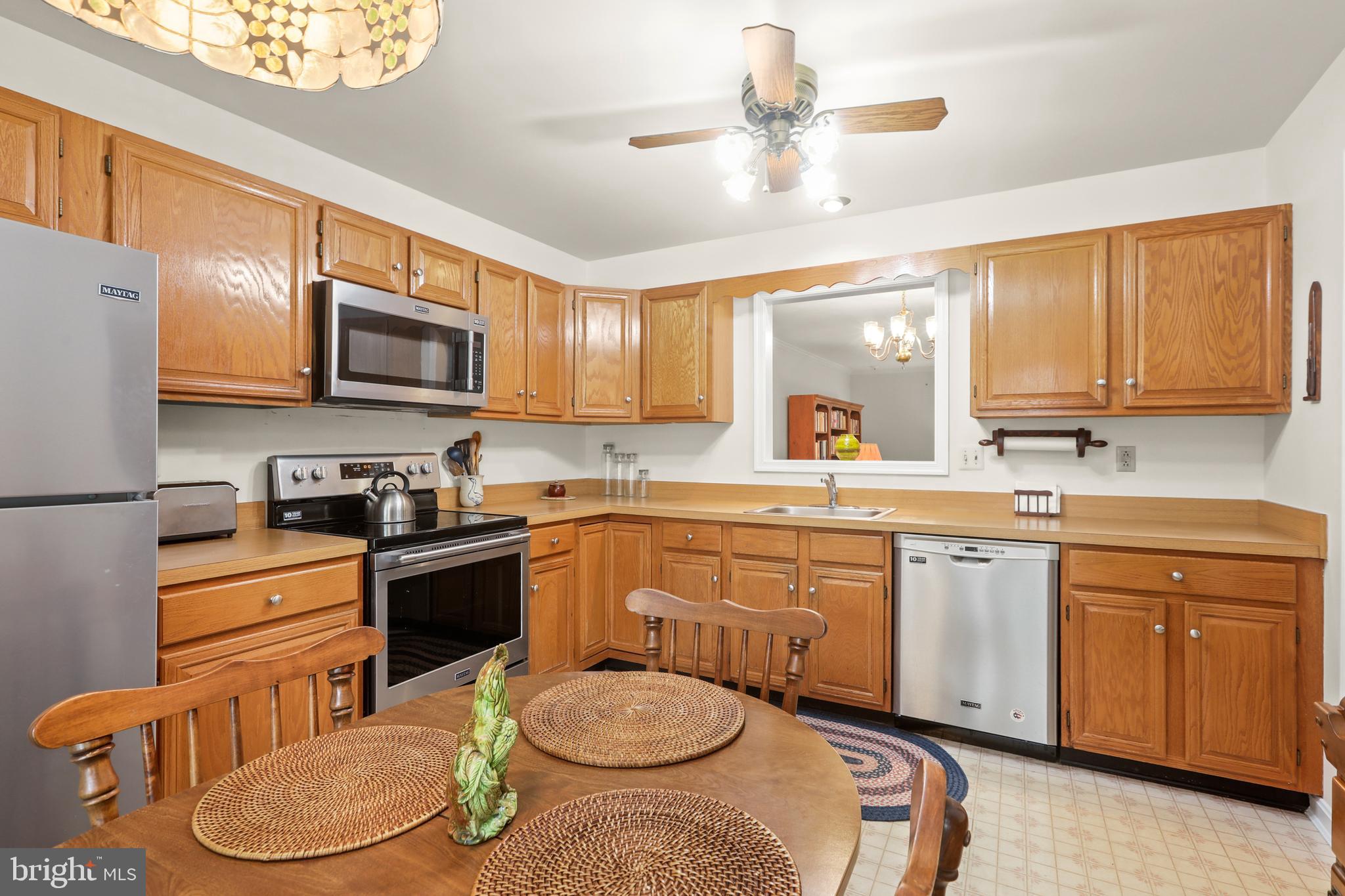 741 Burgh Westra Way Abingdon, MD 21009 - Photo 11 of 48 a kitchen with stainless steel appliances a stove a sink a microwave a refrigerator and cabinets