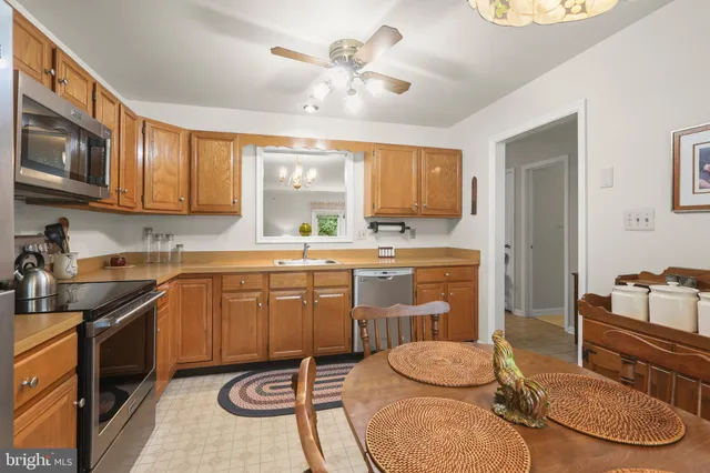 a kitchen with a sink cabinets and window