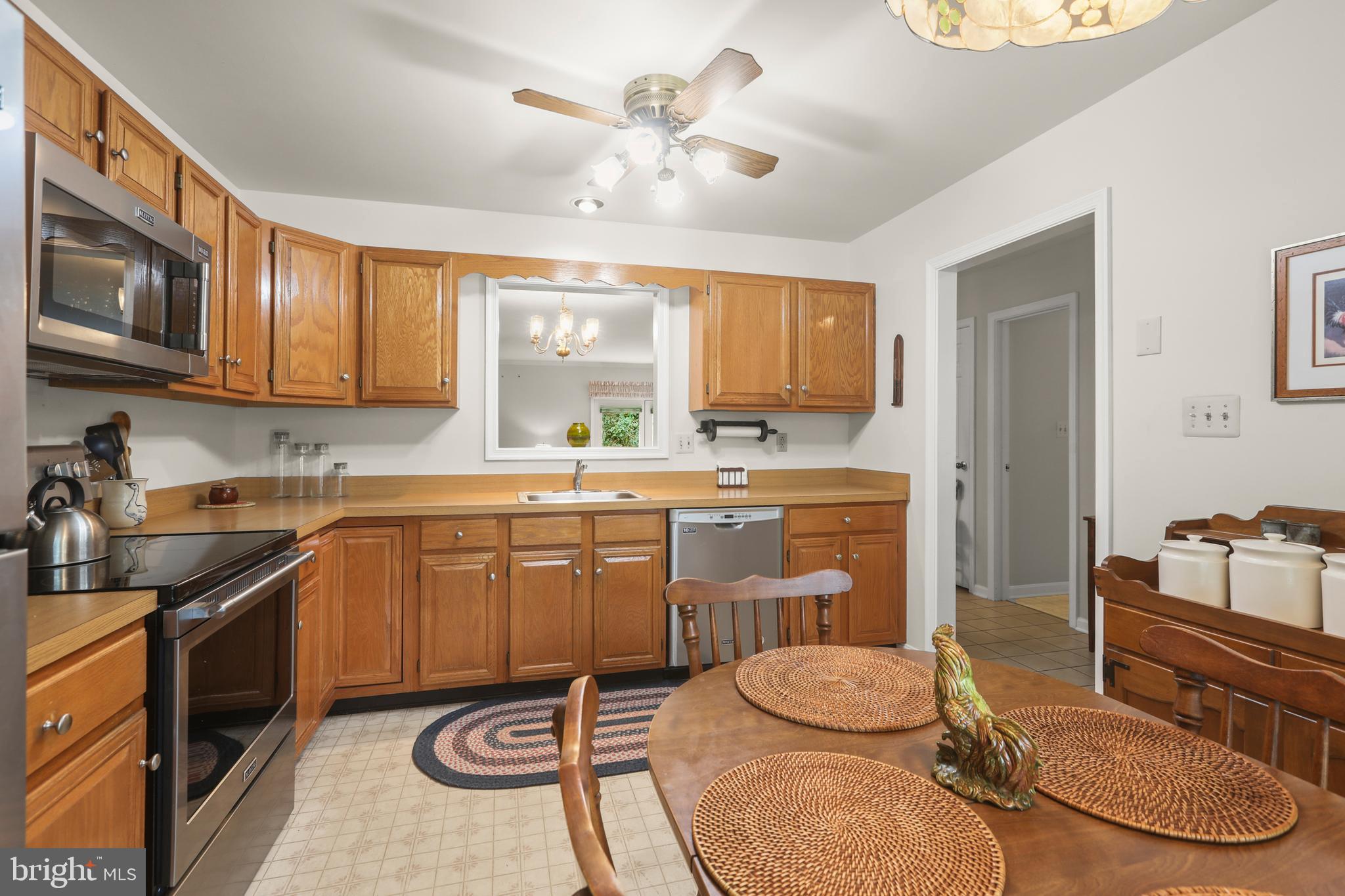 741 Burgh Westra Way Abingdon, MD 21009 - Photo 12 of 48 a kitchen with a sink a stove a dining table and chairs