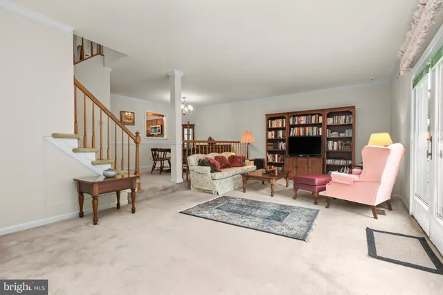 a living room with furniture a rug and a window