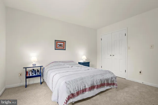 a bedroom with a bed and a couch next to a window