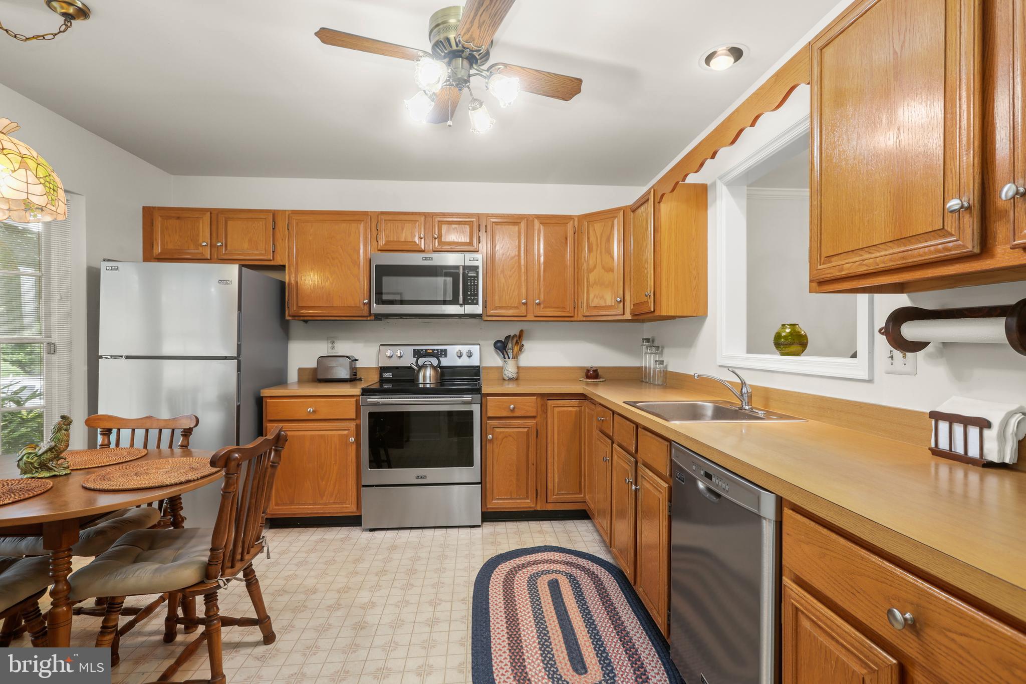 741 Burgh Westra Way Abingdon, MD 21009 - Photo 10 of 48 a kitchen with stainless steel appliances granite countertop a sink a stove a refrigerator cabinets and a dining table