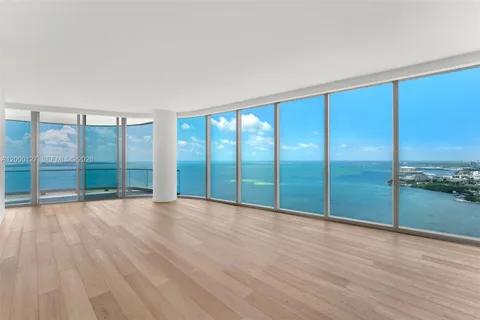wooden floor in an empty room with a large window