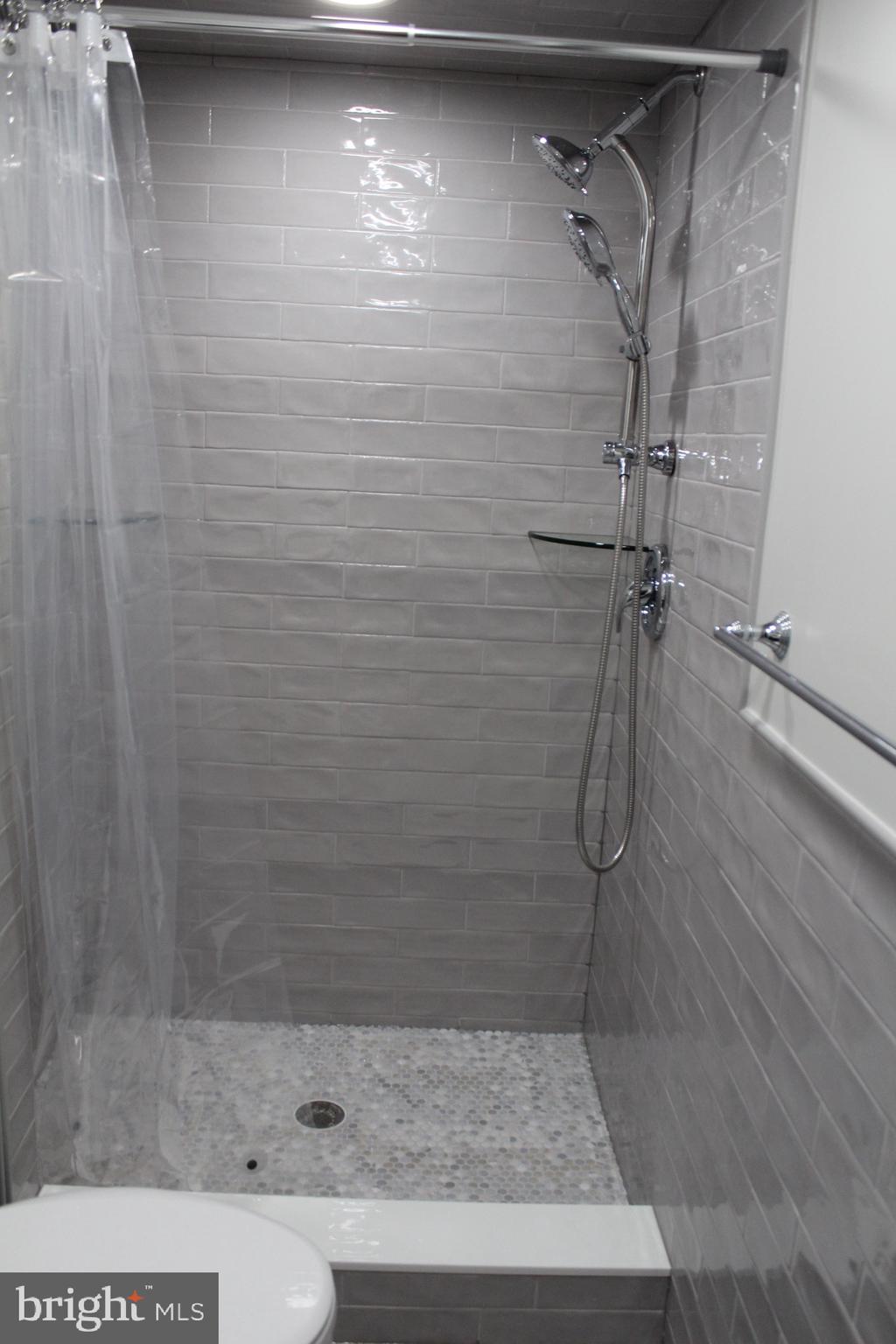 7703 Newcastle Drive Annandale, VA 22003 - Photo 3 of 12 a bathroom with a shower