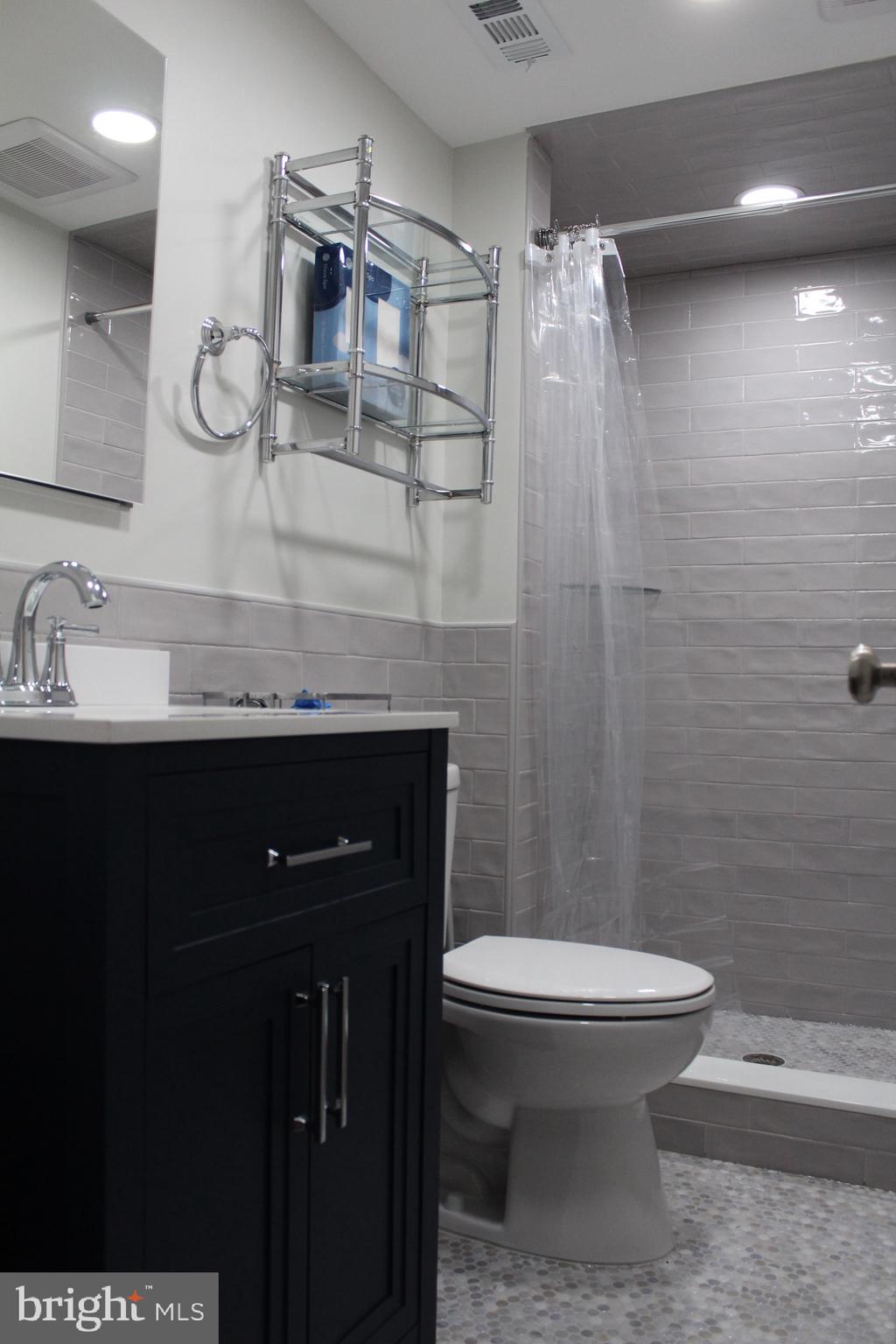 7703 Newcastle Drive Annandale, VA 22003 - Photo 4 of 12 a bathroom with a sink a toilet and shower