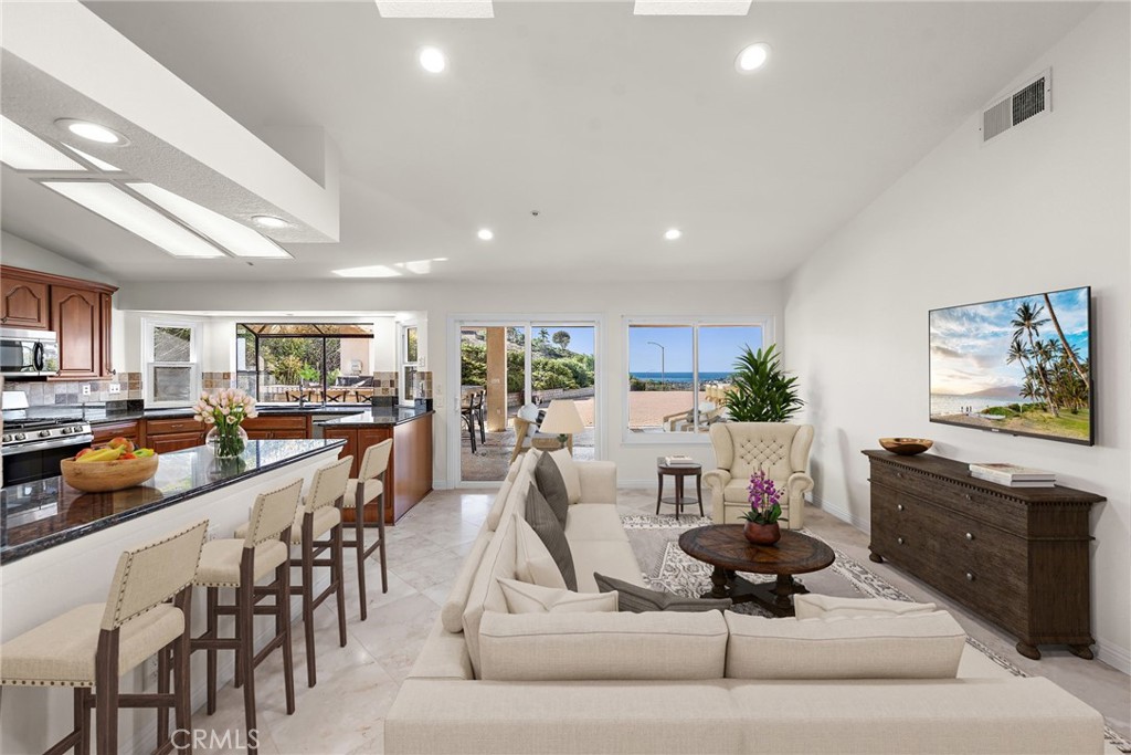 2847 Calle Heraldo San Clemente, CA 92673 - Photo 5 of 16 Spacious family room off the kitchen with a cozy fireplace and your ocean view. *Virtual staging was done on this photo.
