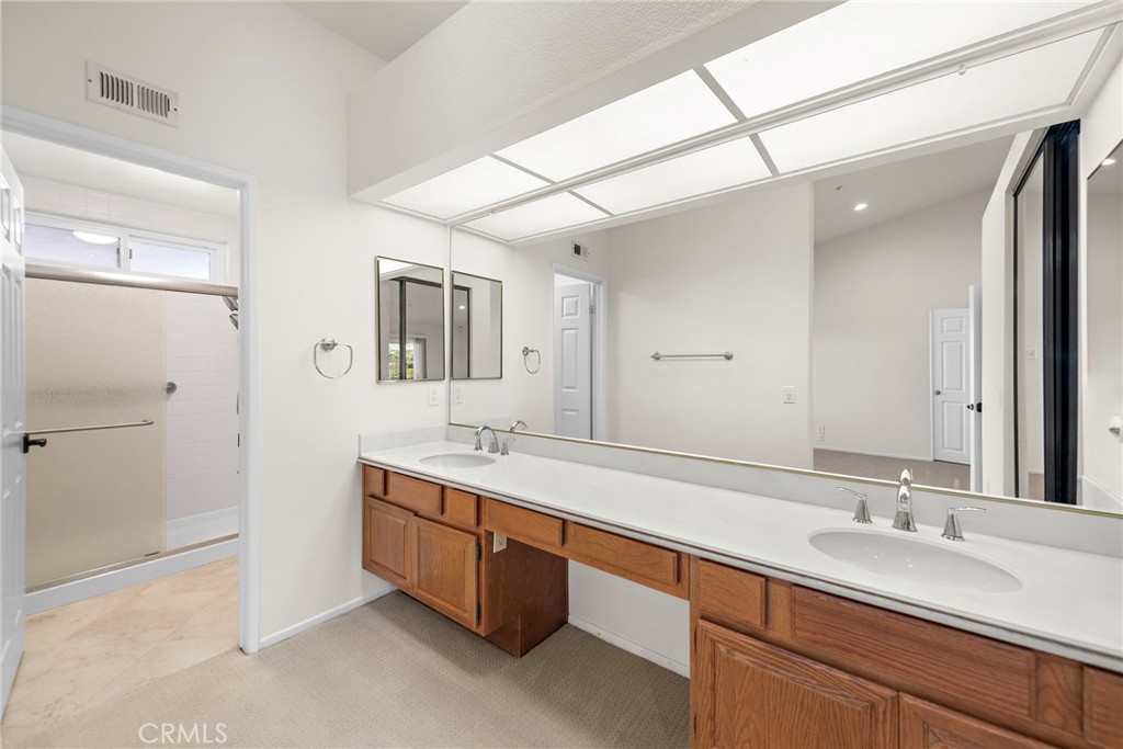 2847 Calle Heraldo San Clemente, CA 92673 - Photo 10 of 16 Primary bathroom with dual sinks, a walk-in shower and private toilet area.
