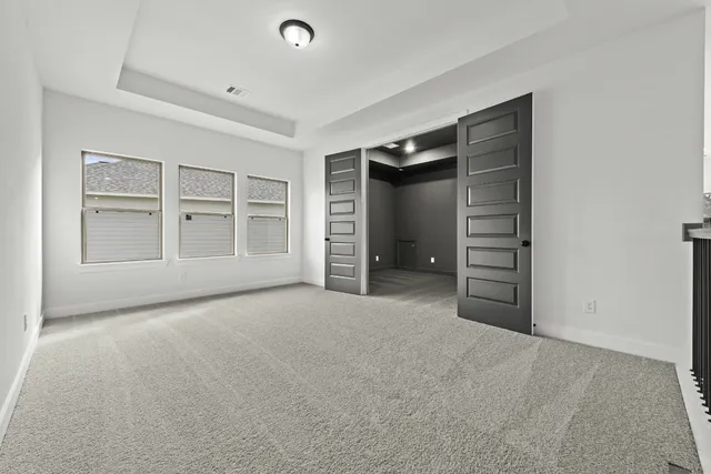 an empty room with closet and entryway