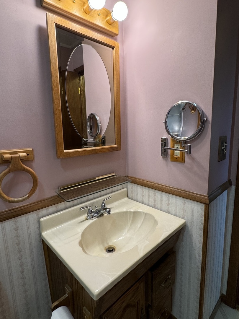 7912 Elm Street Harvard, IL 60033 - Photo 15 of 37 a bathroom with a sink a vanity and a toilet