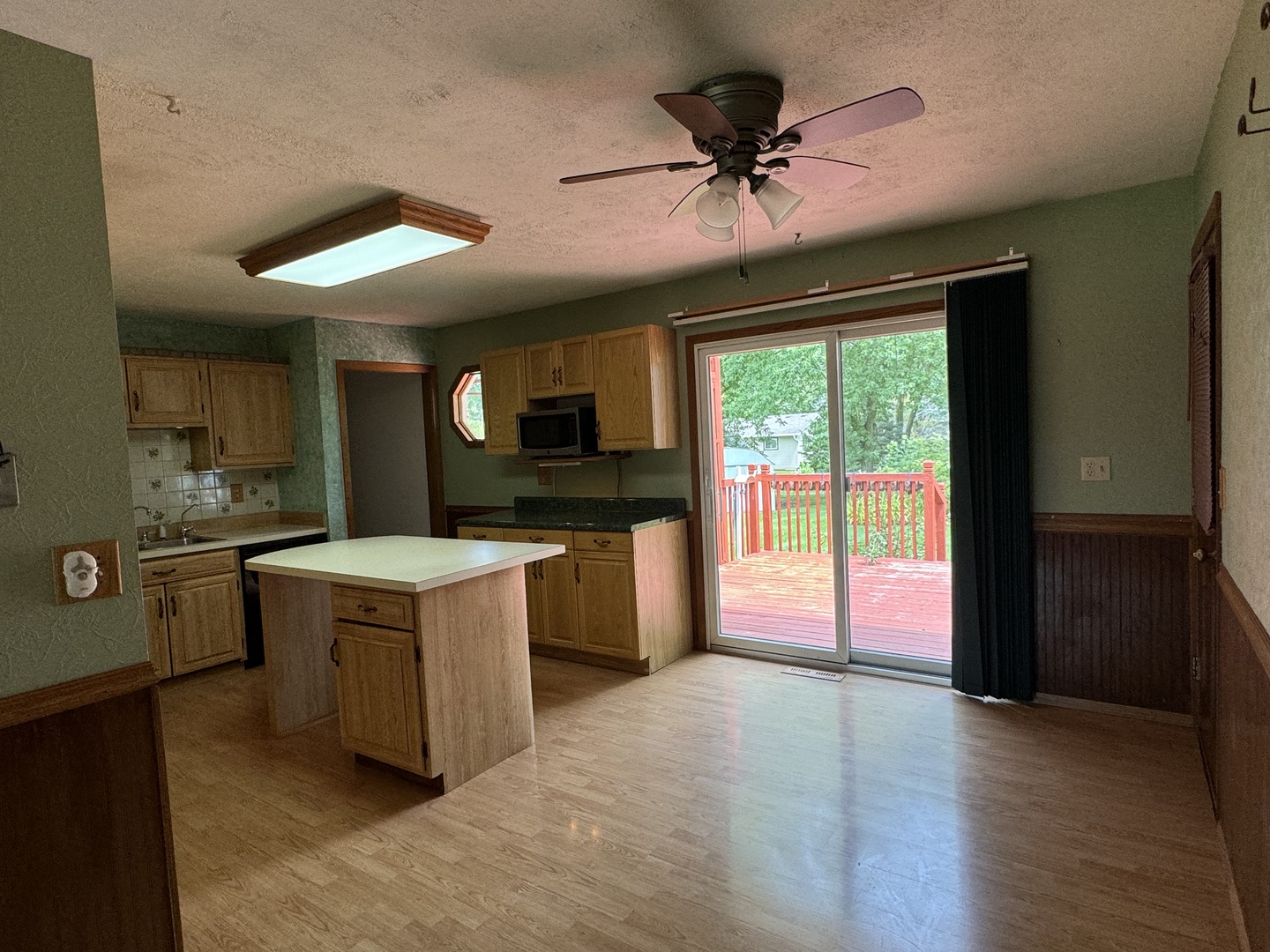 7912 Elm Street Harvard, IL 60033 - Photo 3 of 37 a kitchen with a stove a sink and a refrigerator