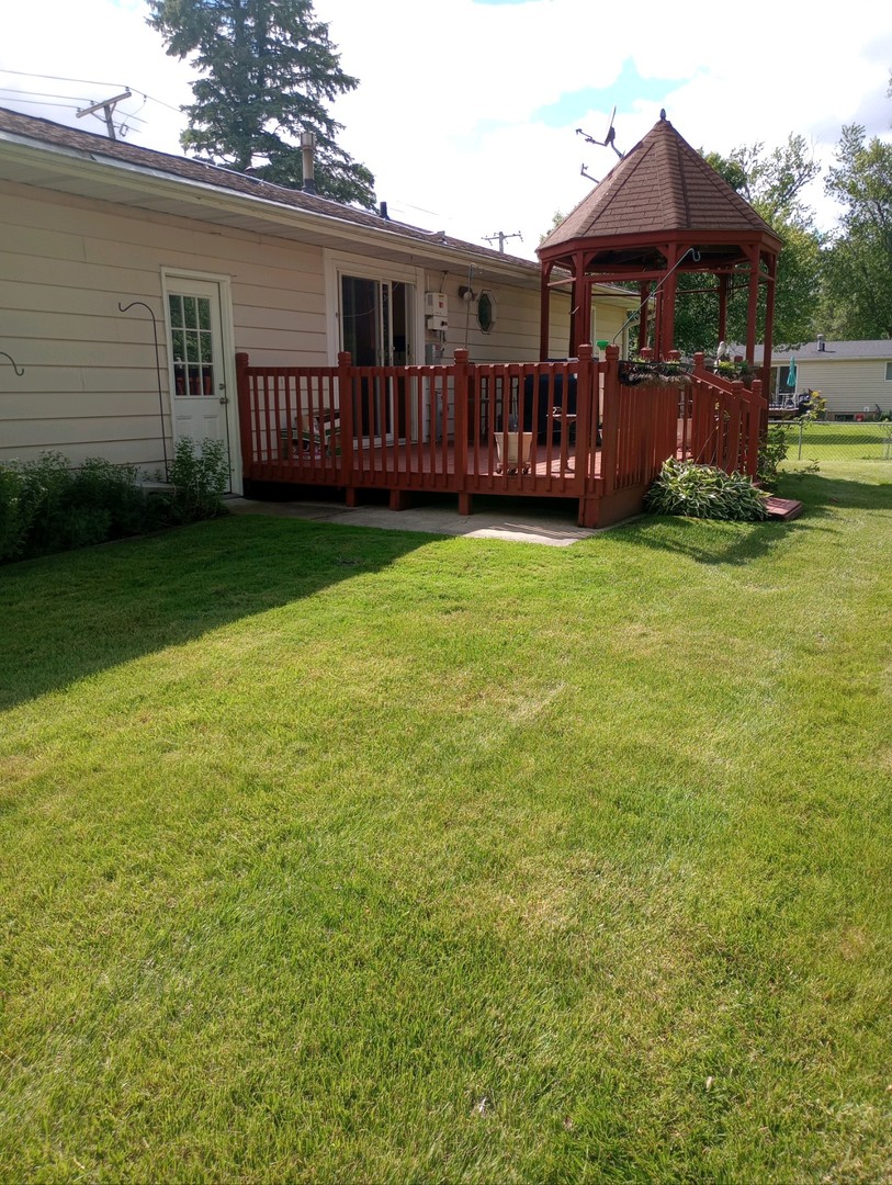 7912 Elm Street Harvard, IL 60033 - Photo 31 of 37 a front view of a house with garden