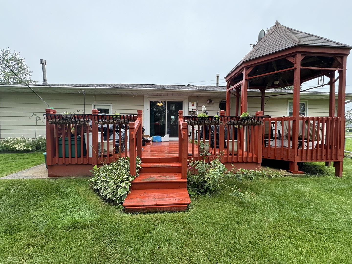 7912 Elm Street Harvard, IL 60033 - Photo 32 of 37 a front view of a house with a yard table and chairs