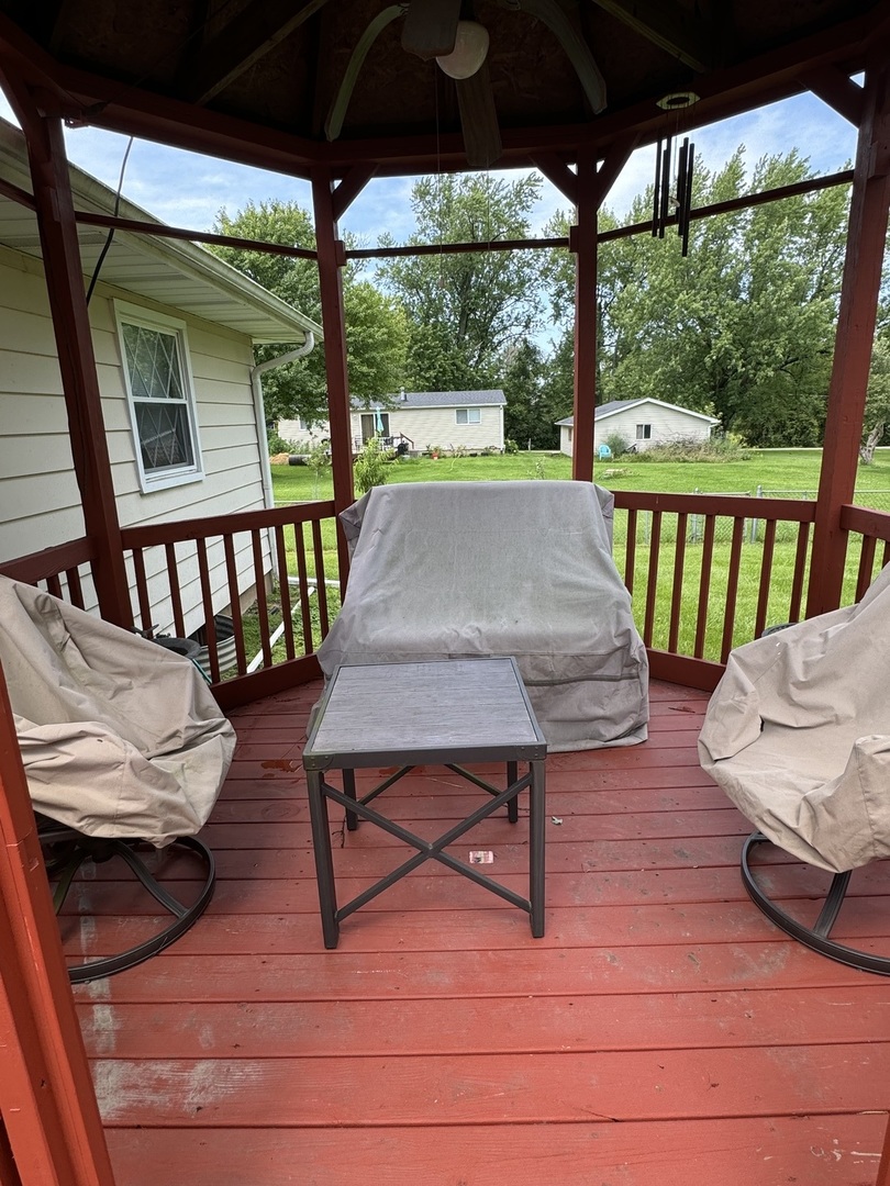 7912 Elm Street Harvard, IL 60033 - Photo 33 of 37 a view of a patio with lawn chairs next to a yard