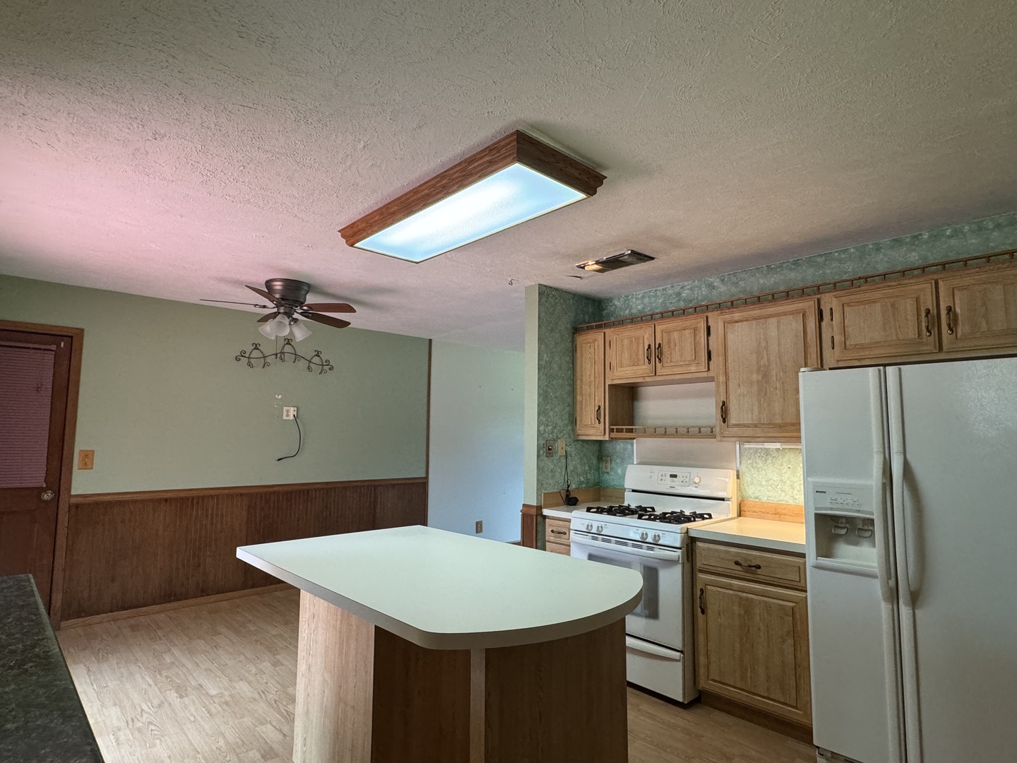 7912 Elm Street Harvard, IL 60033 - Photo 4 of 37 a kitchen with kitchen island a stove a sink dishwasher and a refrigerator