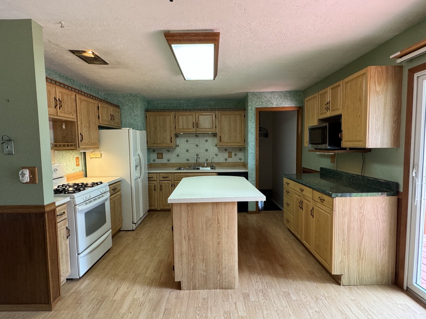 7912 Elm Street Harvard, IL 60033 - Photo 5 of 37 a kitchen with stainless steel appliances granite countertop a stove a sink dishwasher a refrigerator and a oven with wooden floor