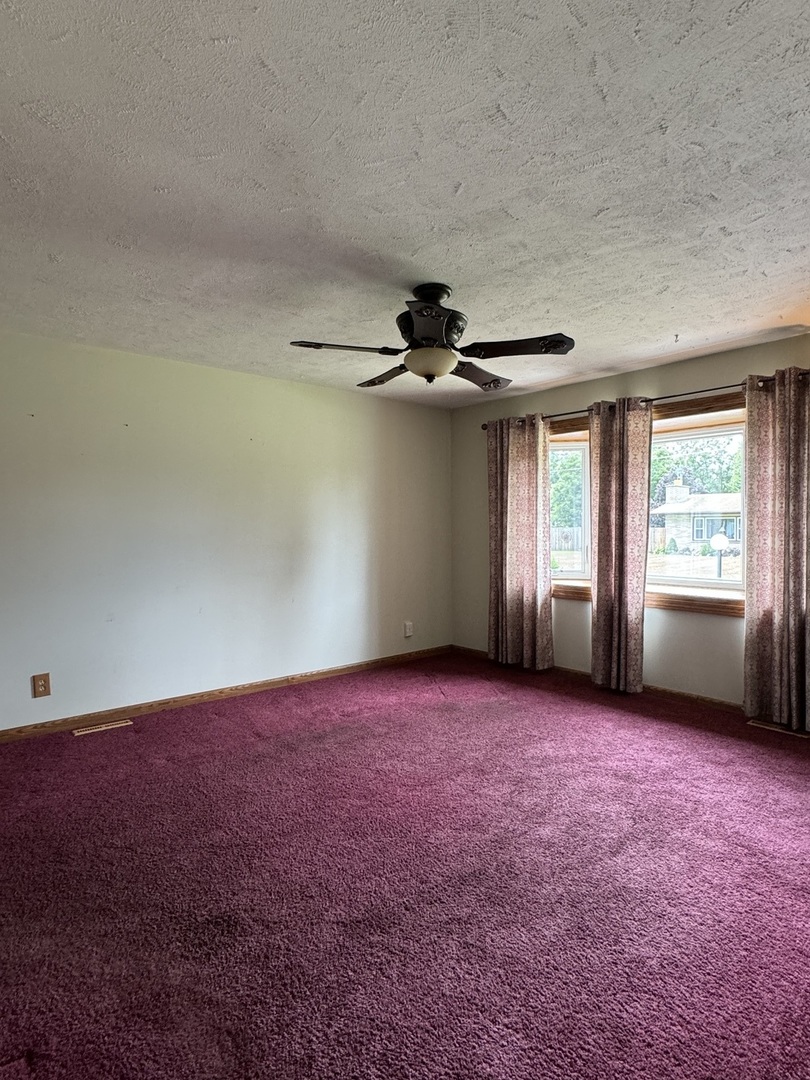 7912 Elm Street Harvard, IL 60033 - Photo 8 of 37 an empty room with windows and fan