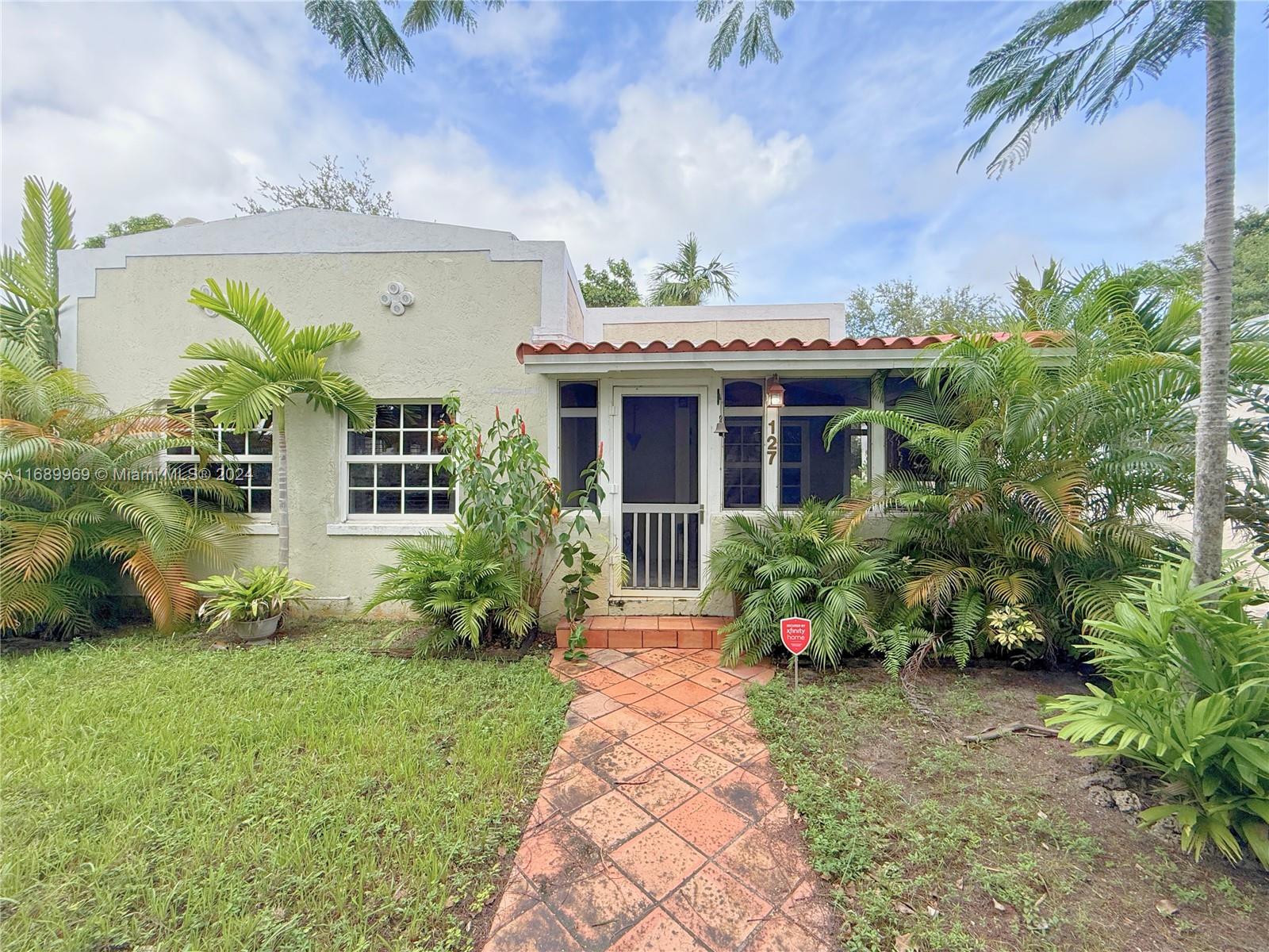 127 Northwest 47th Street Miami, FL 33127 - Photo 2 of 7 a front view of a house with garden