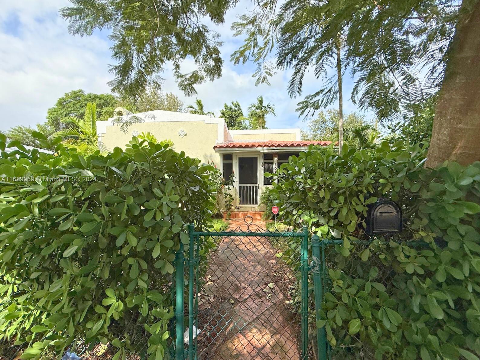 127 Northwest 47th Street Miami, FL 33127 - Photo 3 of 7 a view of a house with a tree