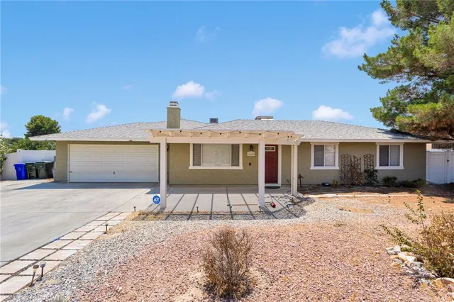a front view of a house with a yard covered with snow