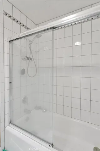 a bathroom with a shower and a bathtub