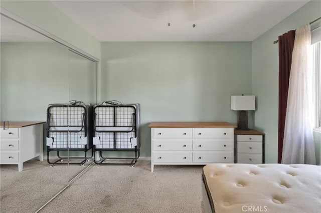 a bedroom with a bed and lamp