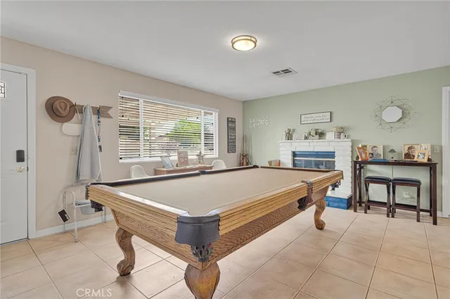 a room with pool table and windows