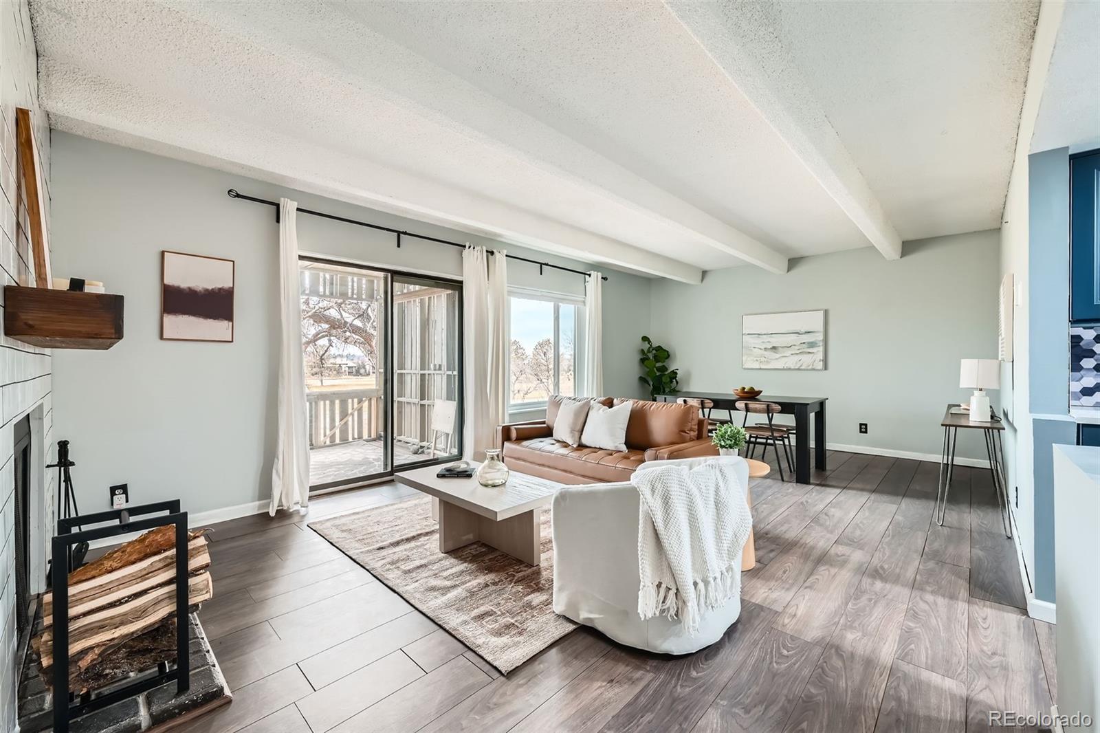 a living room with furniture a flat screen tv and a window