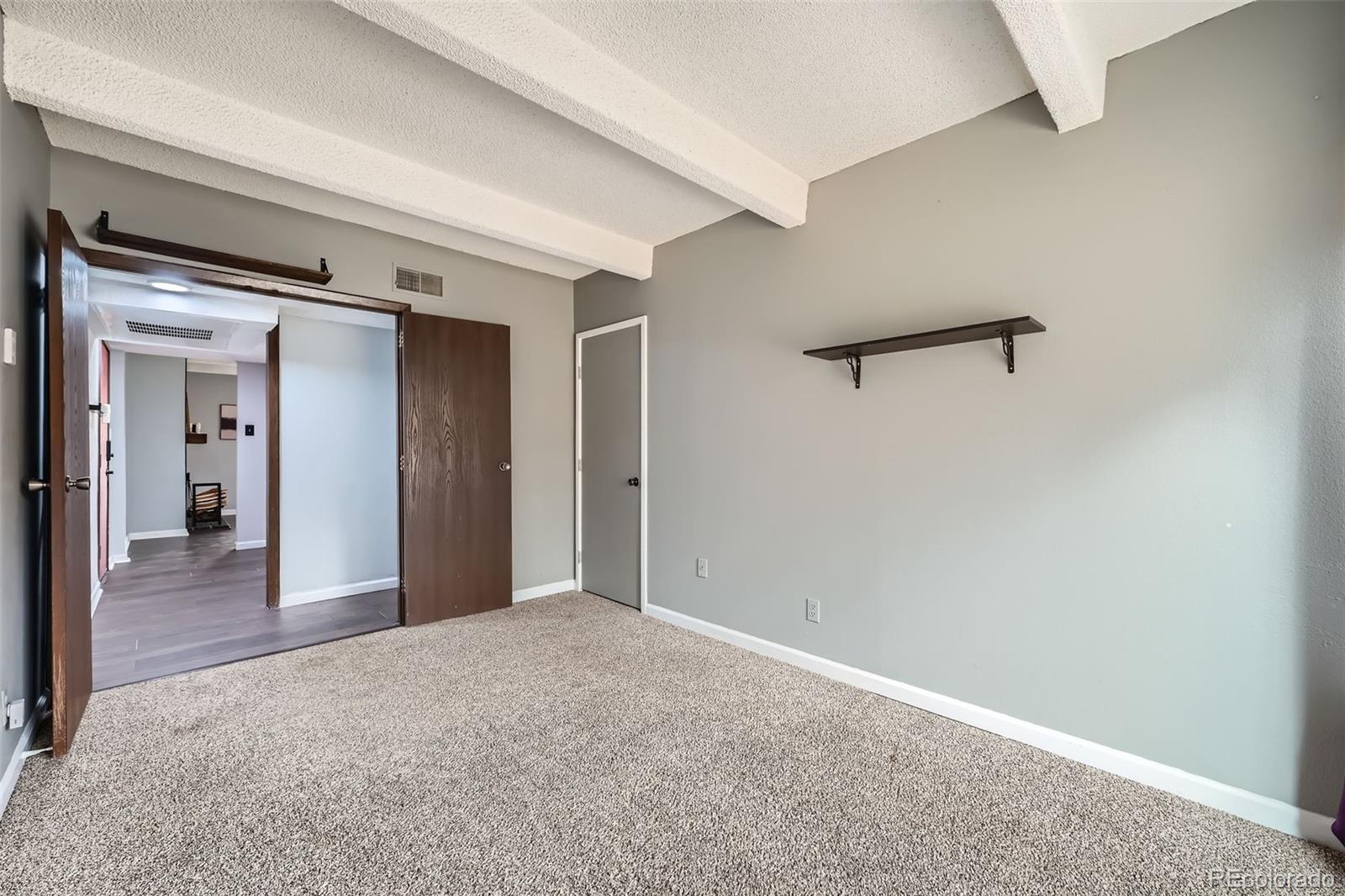 2525 South Dayton Way, Unit 1003 Denver, CO 80231 - Photo 18 of 22 a view of a hallway with wooden floor