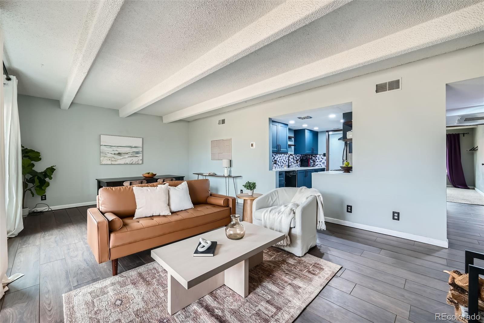2525 South Dayton Way, Unit 1003 Denver, CO 80231 - Photo 2 of 22 a living room with furniture and wooden floor